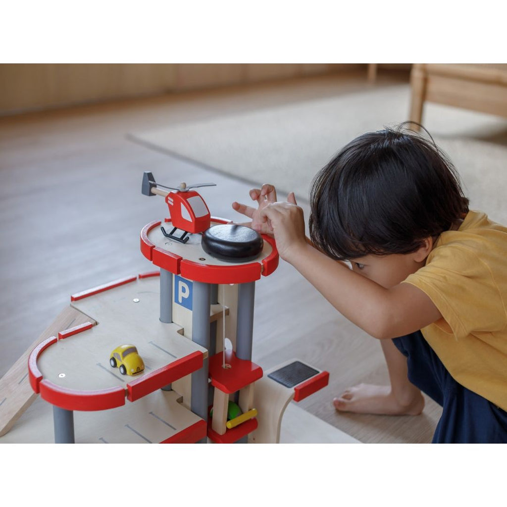 Kid playing PlanToys Helicopter