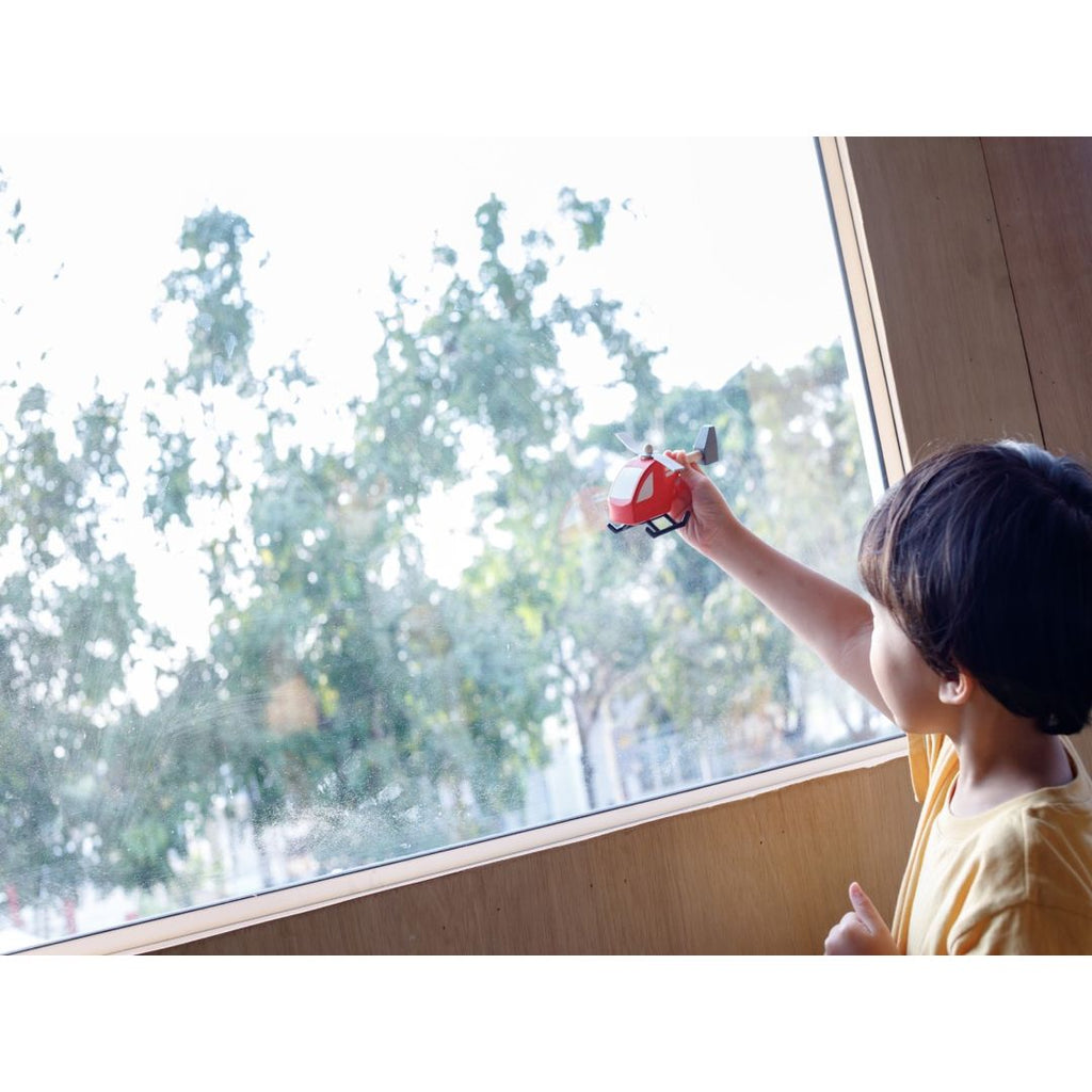 Kid playing PlanToys Helicopter