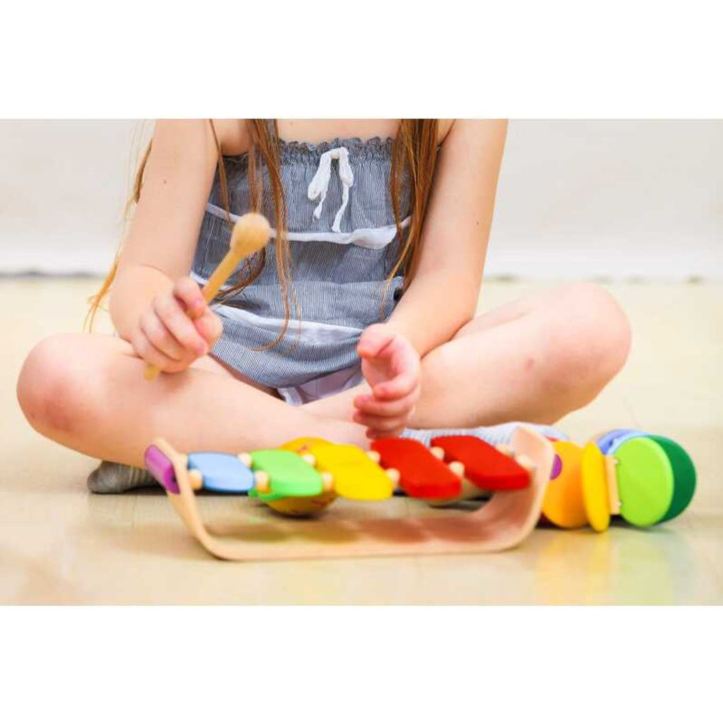 Kid playing PlanToys Oval Xylophone