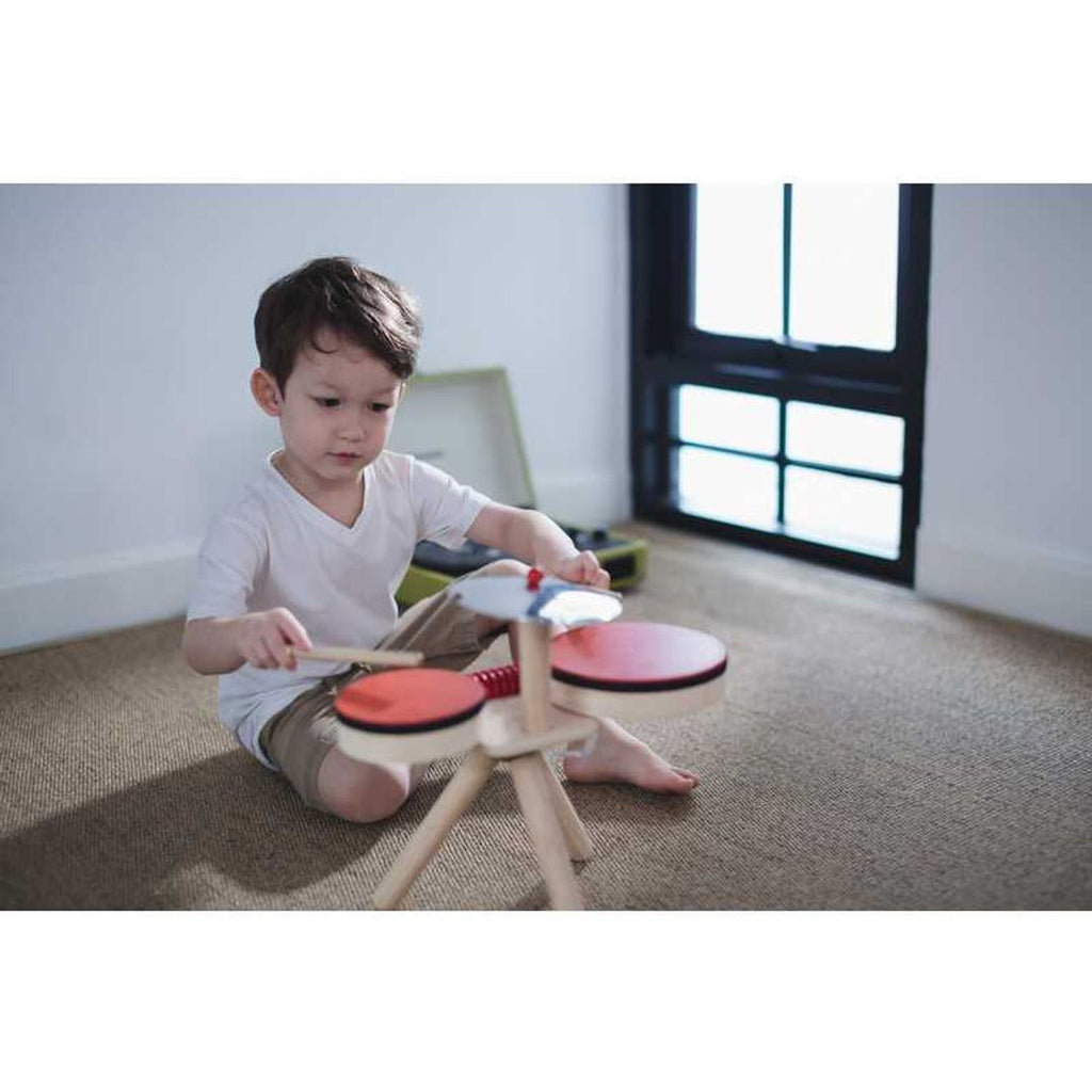 Kid playing PlanToys Musical Band