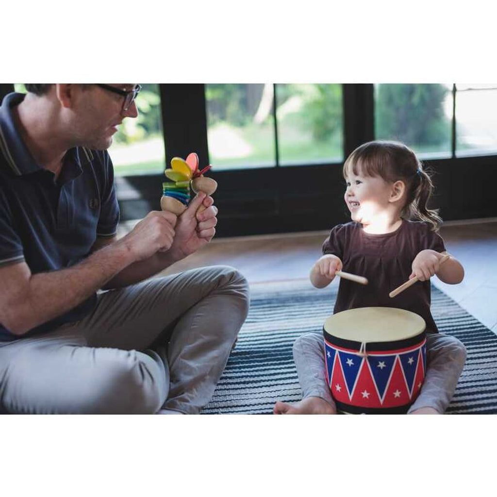 Kid playing PlanToys Big Drum II