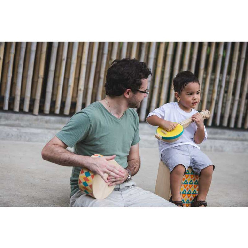 Kid playing PlanToys Banjolele