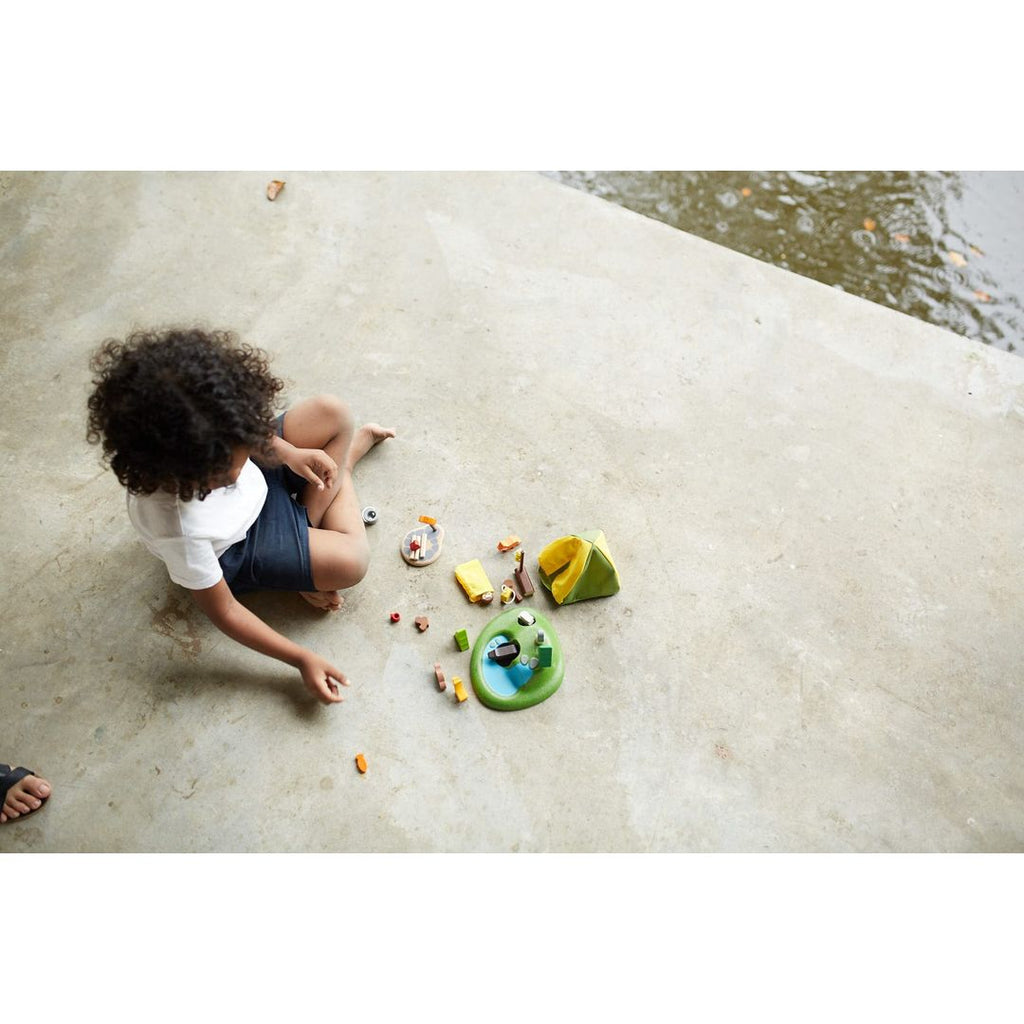 Kid playing PlanToys Camping Set