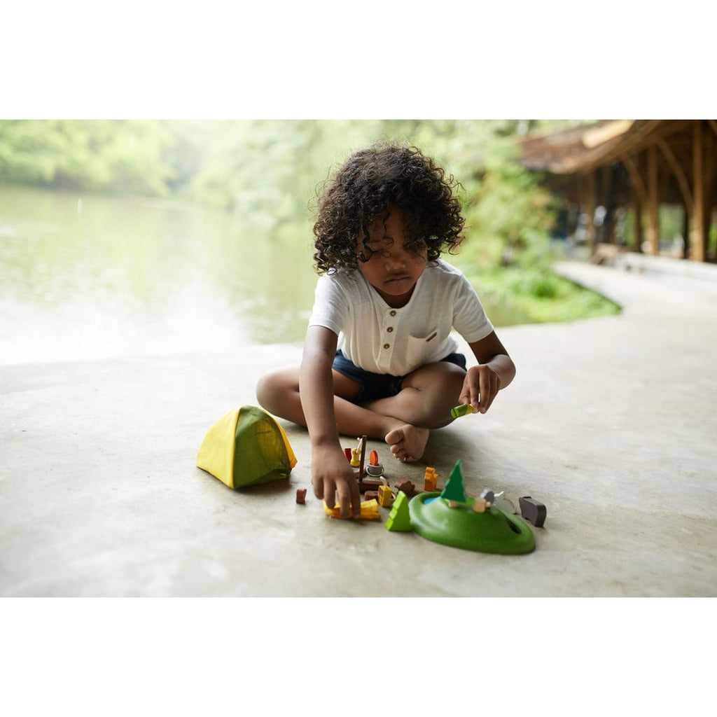 Kid playing PlanToys Camping Set