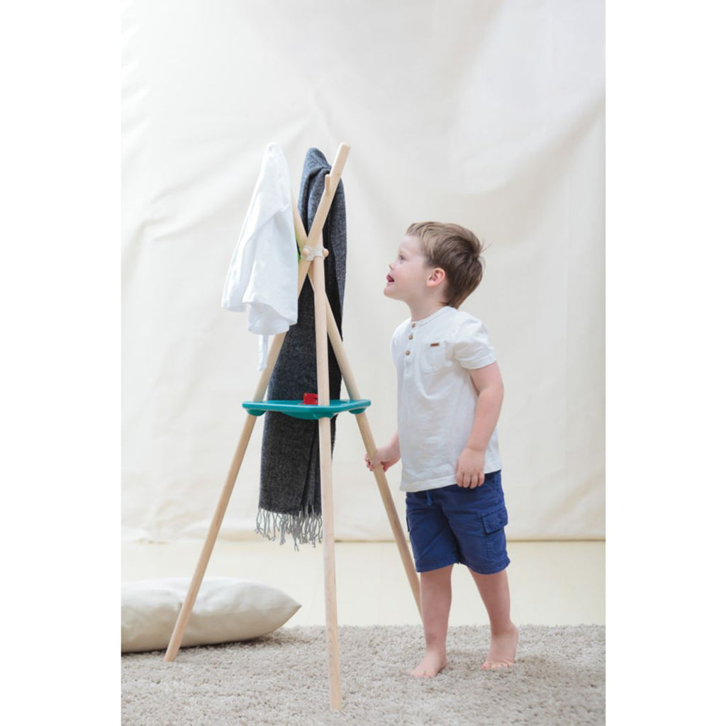 Kid using PlanToys Coat Rack